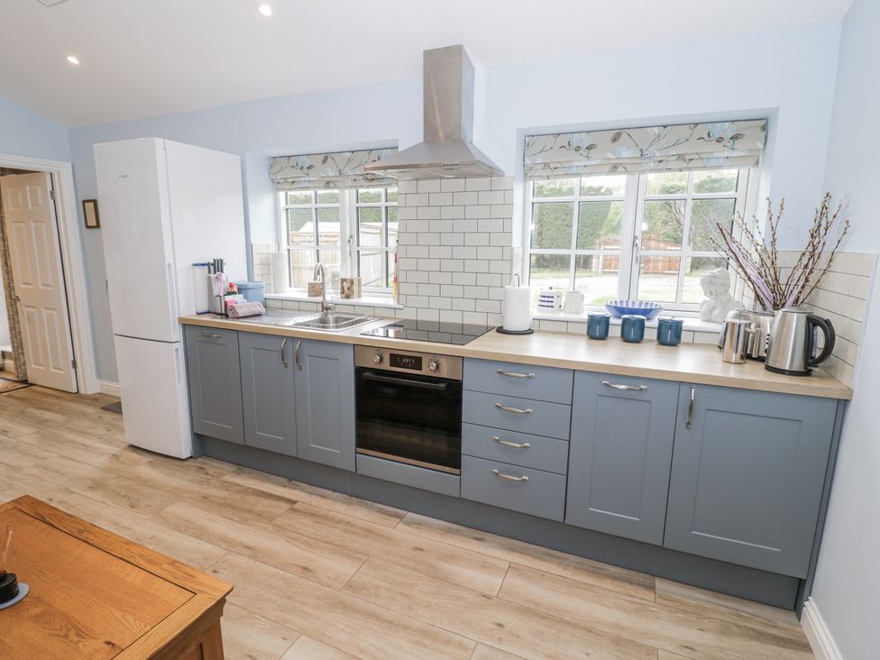 A kitchen with cabinets and appliances at Rose Stables in Black Bourton near Bampton