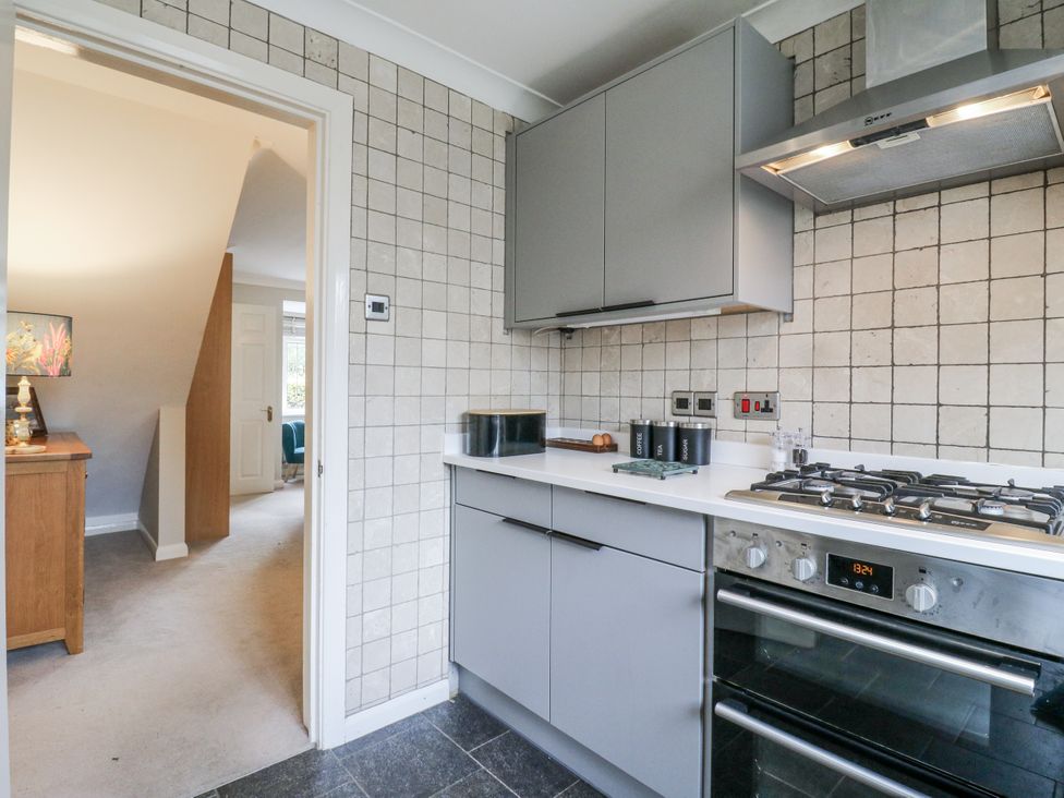 A kitchen with cabinets and appliances at 32 Abbey Gardens
