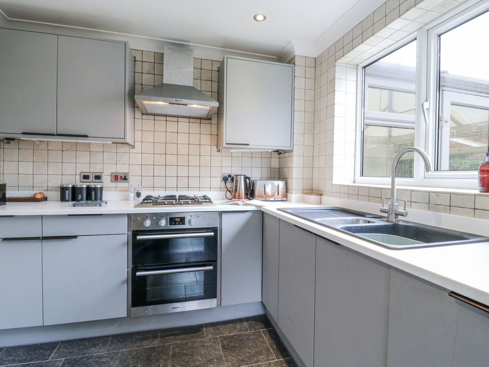 A kitchen with cabinets and appliances at 32 Abbey Gardens