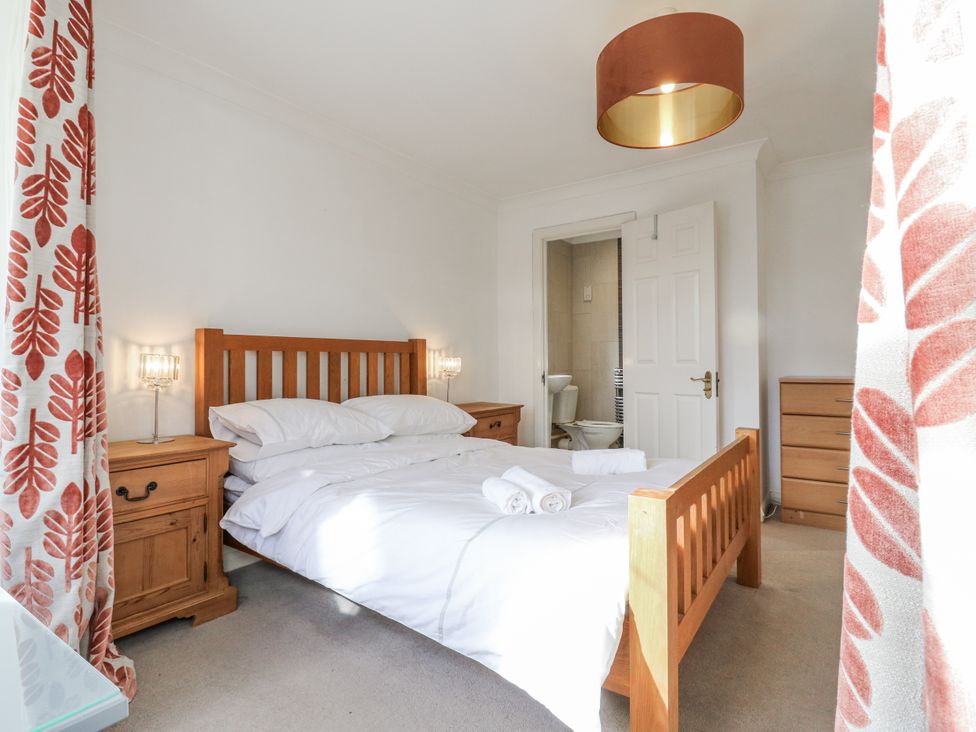 A bedroom with a bed and dresser at 32 Abbey Gardens