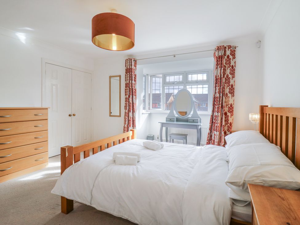 A bedroom with a bed and dresser at 32 Abbey Gardens