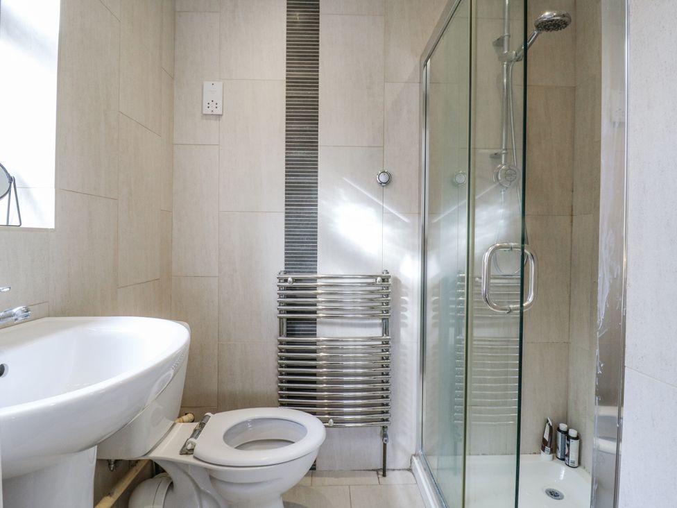 A bathroom with a sink, toilet, and shower at 32 Abbey Gardens