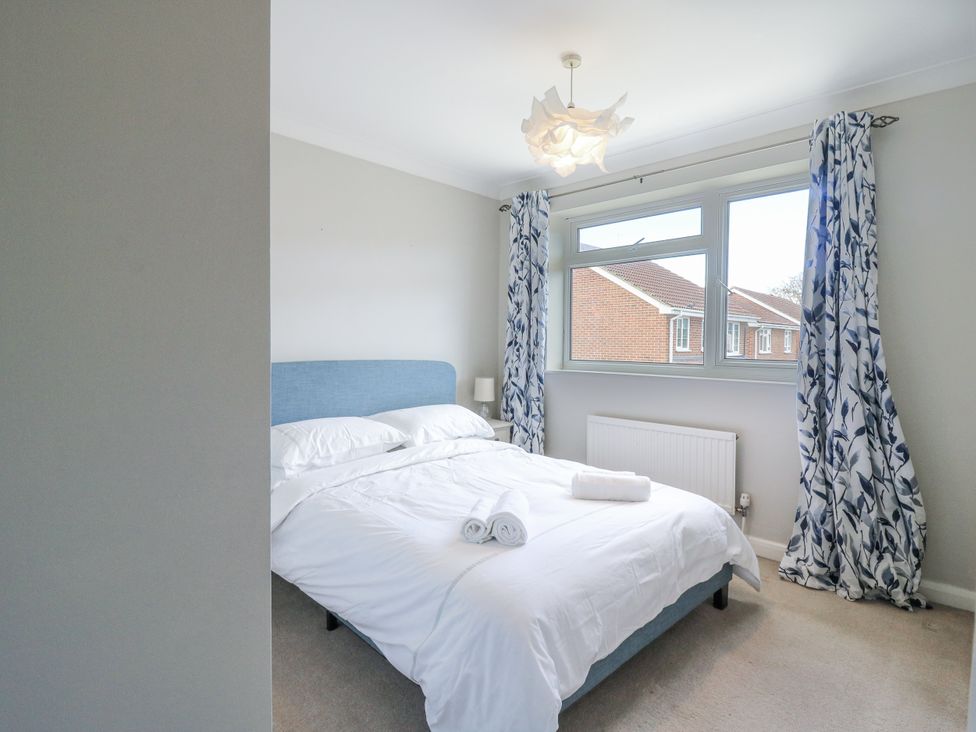 A bedroom with a bed and window at 32 Abbey Gardens