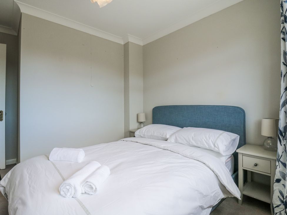 A bedroom with a bed and bedside table at 32 Abbey Gardens