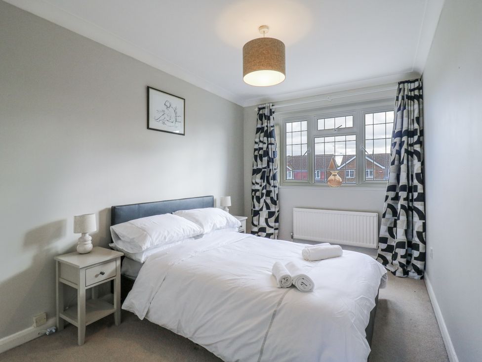 A bedroom with a bed and bedside table at 32 Abbey Gardens