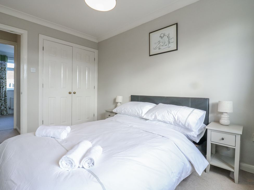 A bedroom with a bed and nightstand at 32 Abbey Gardens