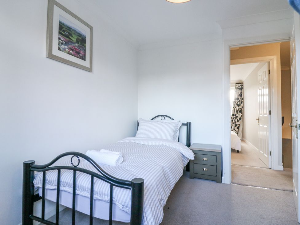 A bedroom with a bed and nightstand at 32 Abbey Gardens