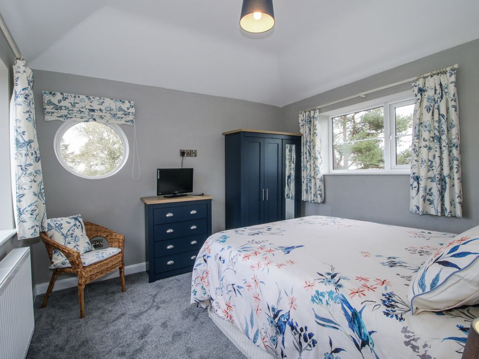 A bedroom with a bed and furniture at Garden Cottage in Ellesmere