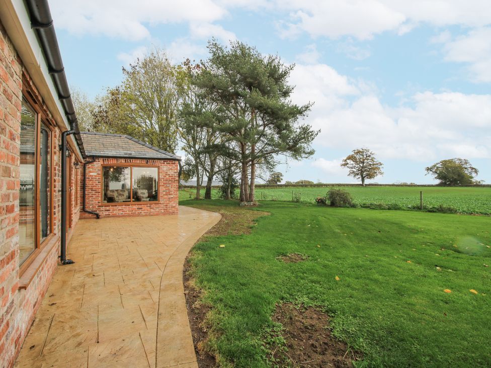 An outdoor view featuring a patio and garden at Garden Cottage in Ellesmere