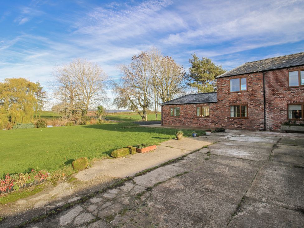 An outdoor area with a house and garden at Garden Cottage in Cockshutt