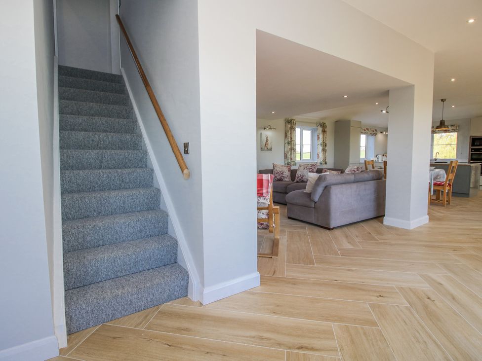 A hallway with stairs leading to upper floor at Garden Cottage in Cockshutt