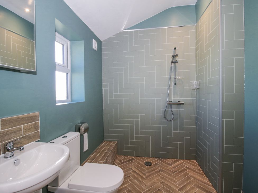 A bathroom with a shower, sink, and toilet at Garden Cottage in Cockshutt