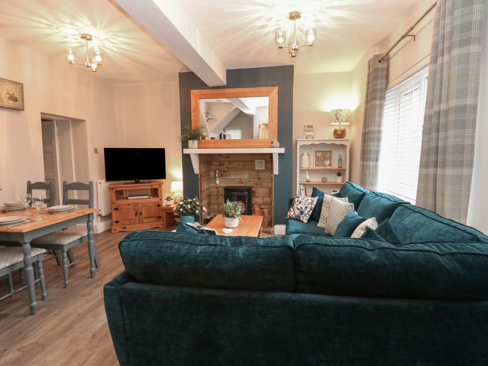 A living room with a television and a sofa at 57 Cockpit Hill in Northallerton