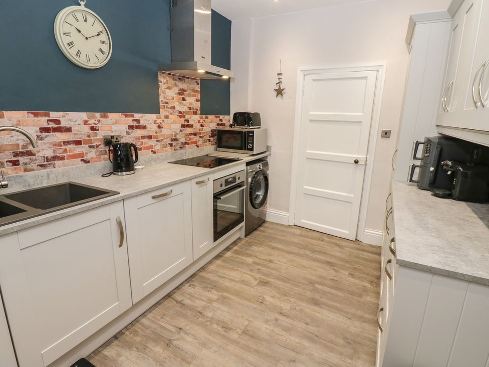 A kitchen with appliances and cabinets at 57 Cockpit Hill Northallerton