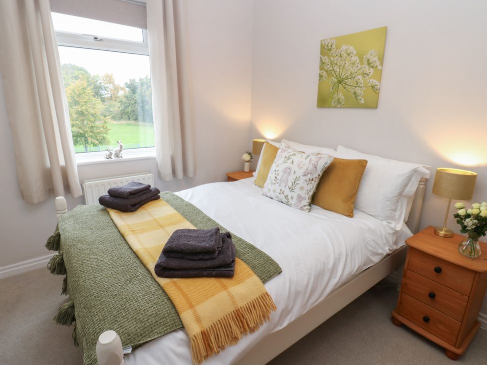 A bedroom with a bed and nightstand at 57 Cockpit Hill Northallerton