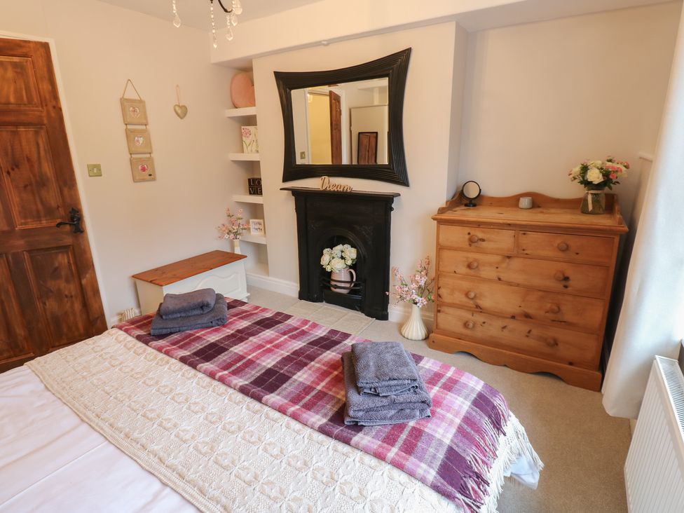 A bedroom with a bed and a fireplace at 57 Cockpit Hill Northallerton