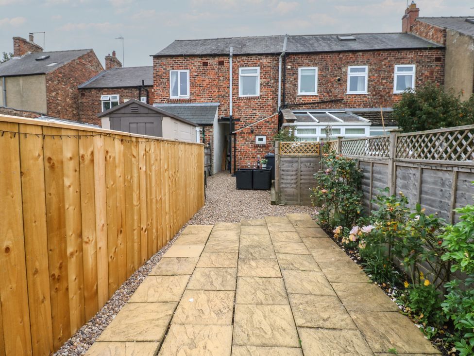 A garden with paving stones and a shed at 57 Cockpit Hill in Northallerton
