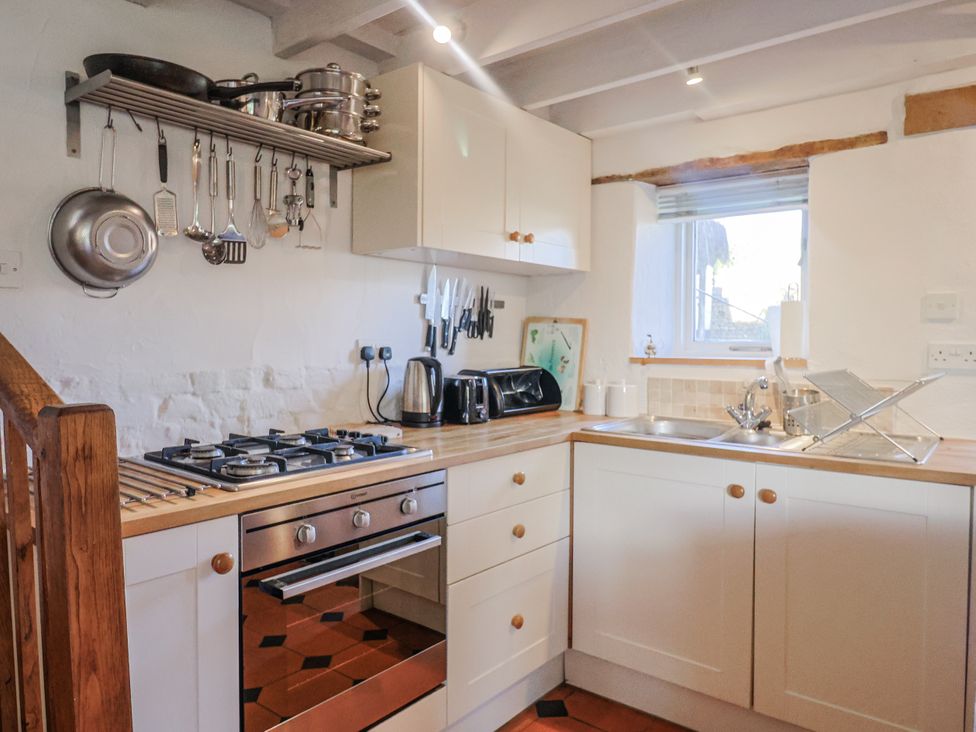A kitchen with a gas stove and sink at The Little Barn Fluxton Nr. Ottery St Mary