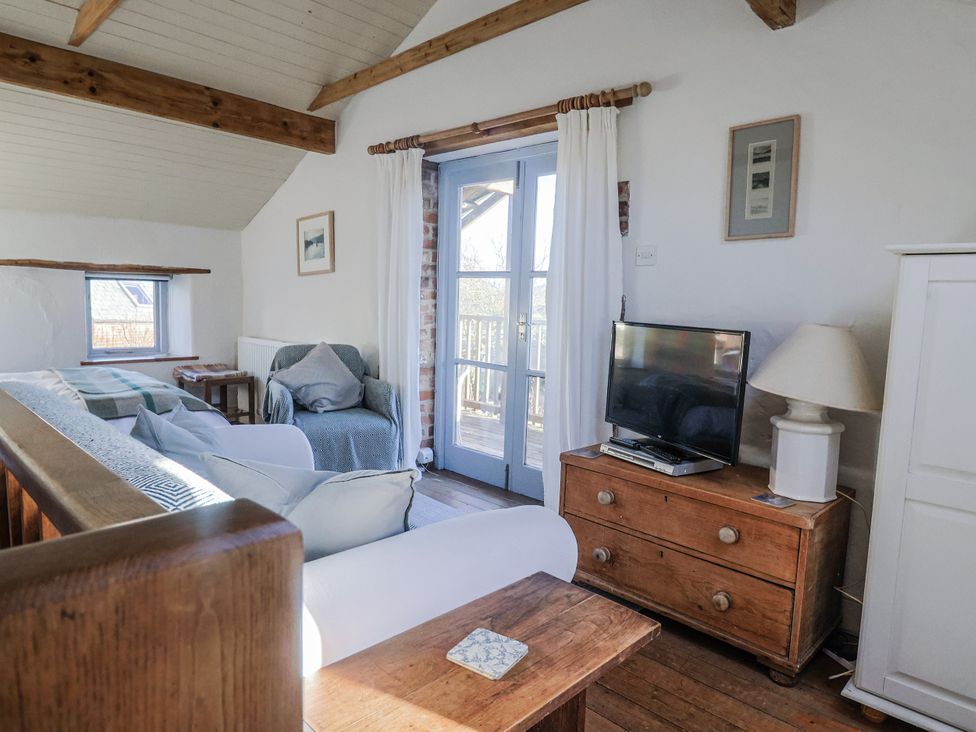A living room with a sofa and television at The Little Barn Fluxton Nr. Ottery St Mary