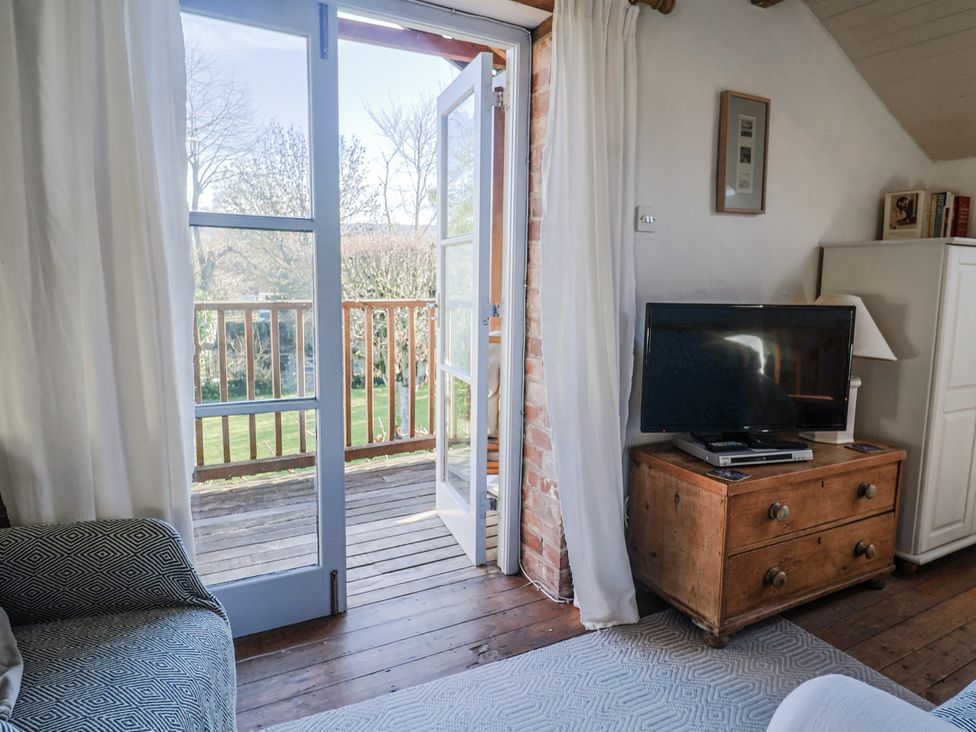 A living room with a television and sofa at The Little Barn Fluxton Nr. Ottery St Mary