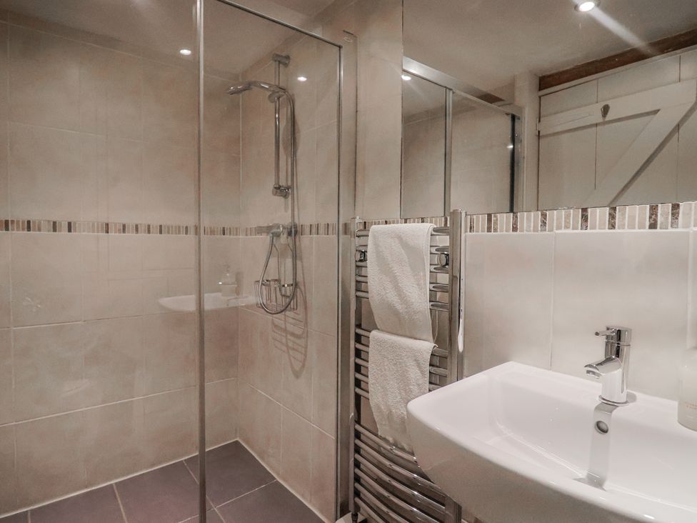 A bathroom with a shower and sink at The Little Barn in Fluxton Nr. Ottery St Mary