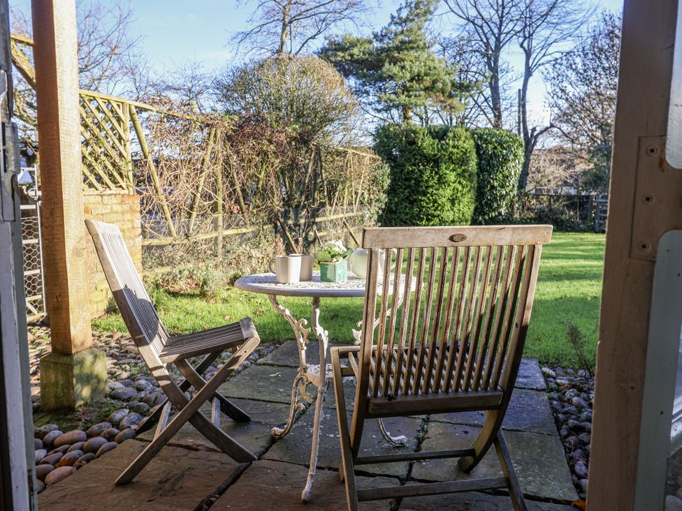 A table and chairs in a garden at The Little Barn Fluxton Nr. Ottery St Mary