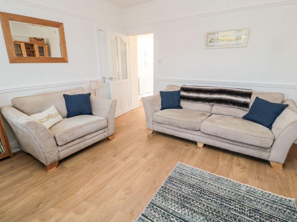 A living room with sofas and a rug at 23 Northumbria Terrace in Amble