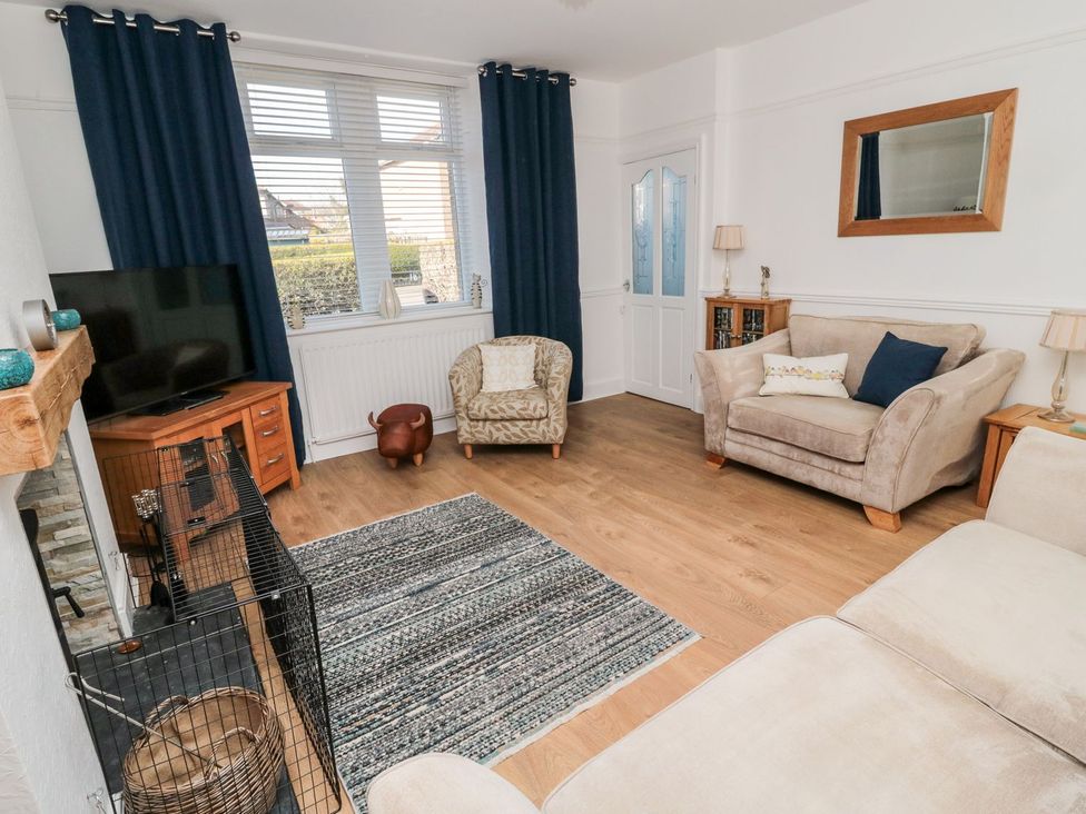 A living room with a television and sofa at 23 Northumbria Terrace in Amble