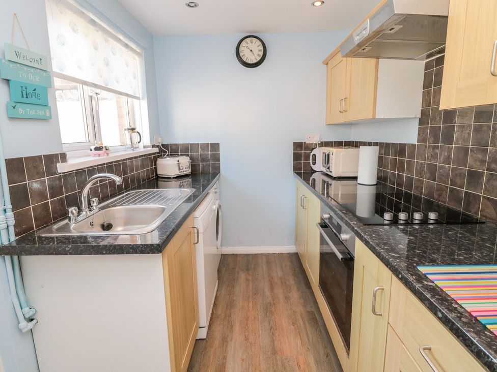 A kitchen with appliances and counter space at 23 Northumbria Terrace in Amble