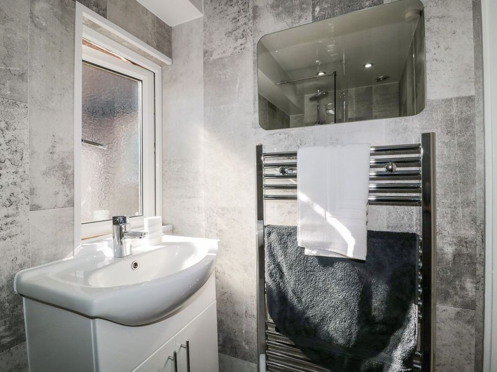 A bathroom with a sink and towel rail at 23 Northumbria Terrace Amble