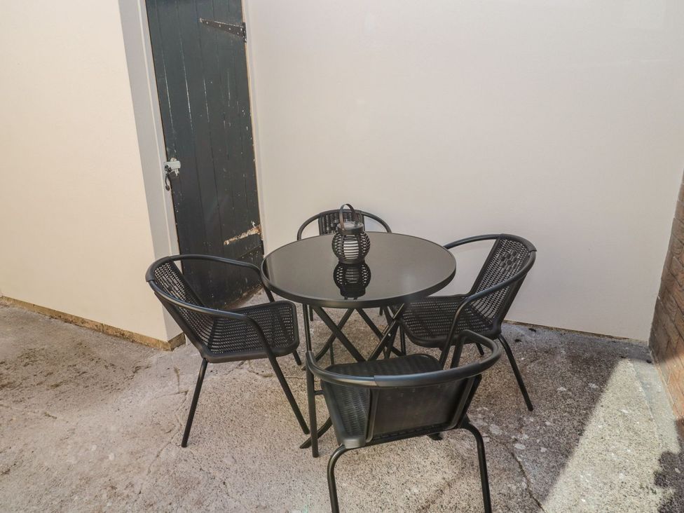 A patio with a table and chairs at 23 Northumbria Terrace Amble