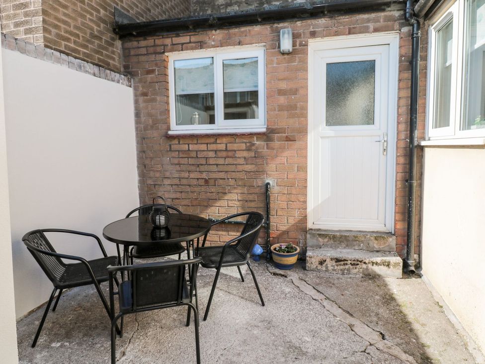A patio area with a table and chairs at 23 Northumbria Terrace in Amble