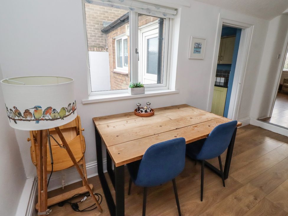A dining area with a table and lamp at 23 Northumbria Terrace Amble