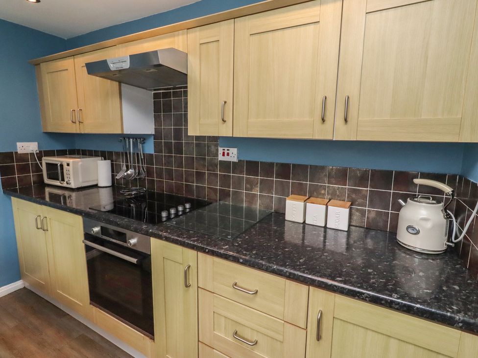 A kitchen with modern appliances at 23 Northumbria Terrace in Amble