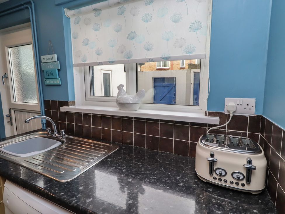A kitchen with a sink and a toaster at 23 Northumbria Terrace Amble