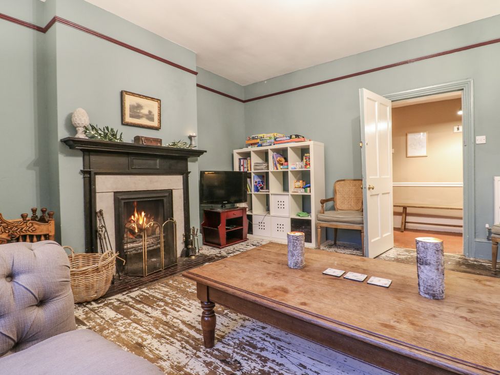 A living room with a fireplace and coffee table at The Farmhouse in Whitchurch, Buckinghamshire