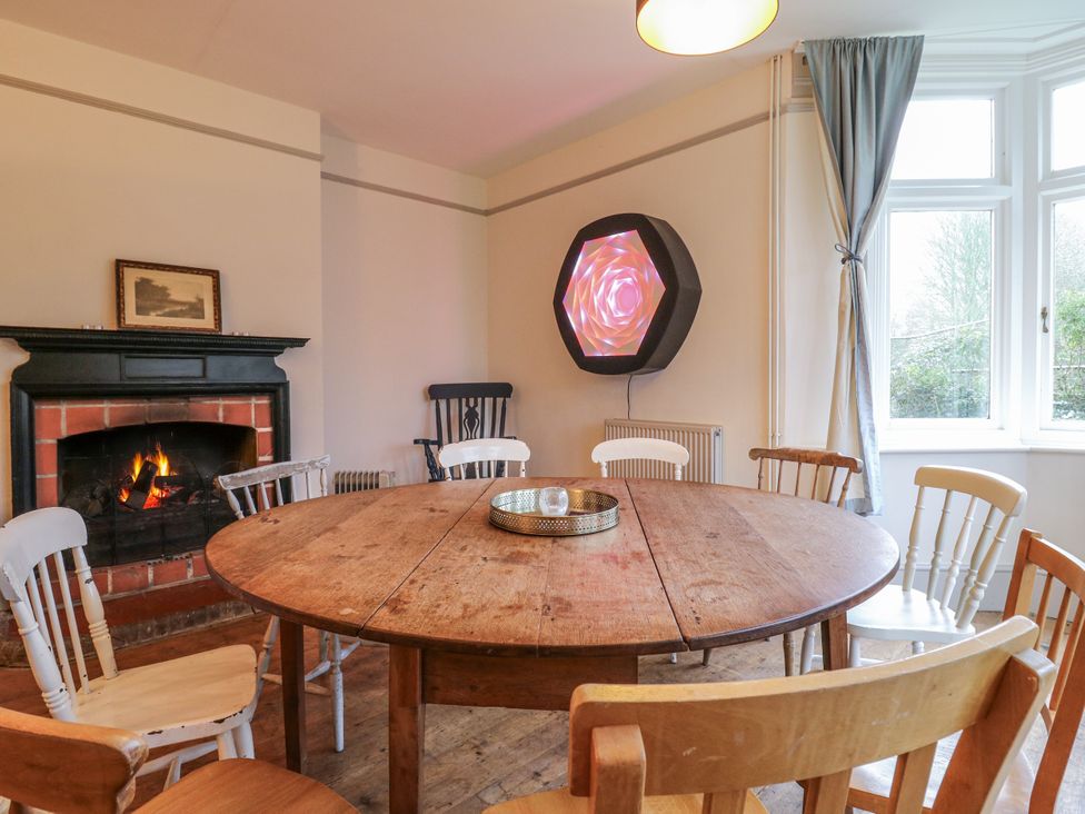 A dining room with a round table and chairs at The Farmhouse in Whitchurch, Buckinghamshire