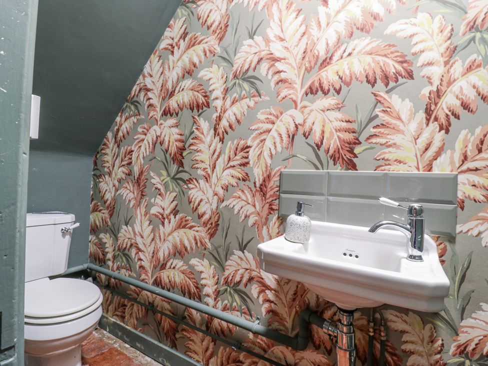 A bathroom with a toilet and sink at The Farmhouse in Whitchurch, Buckinghamshire