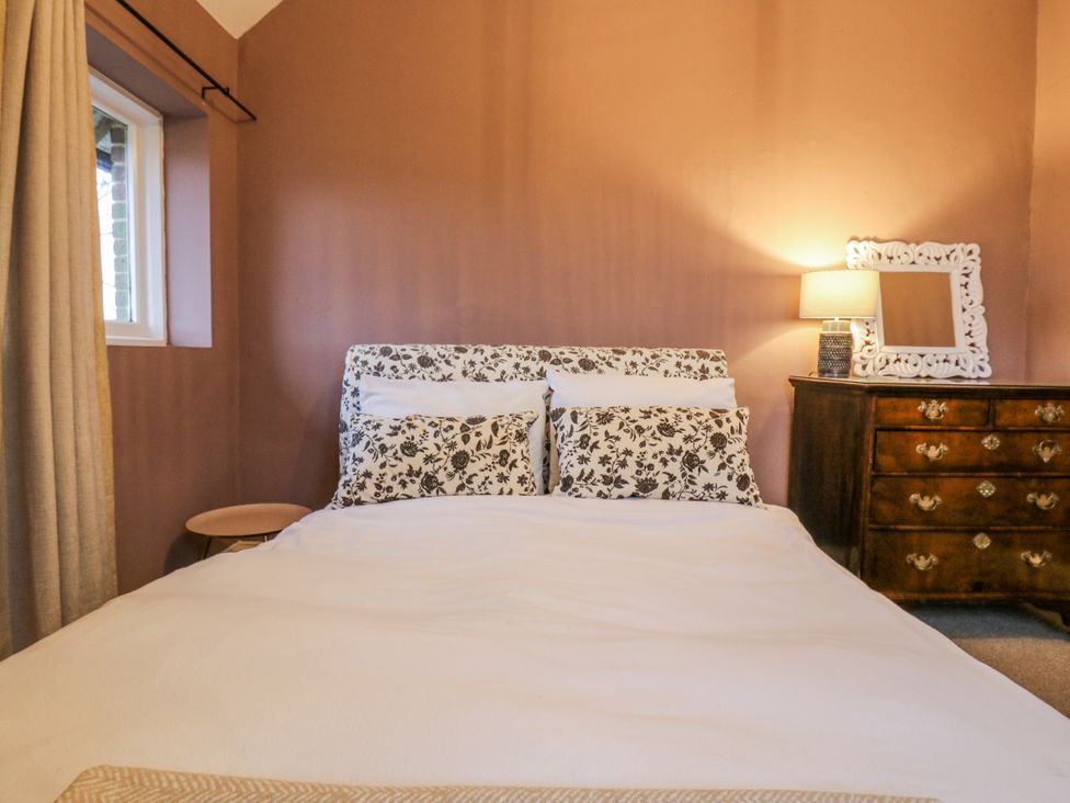A bedroom with a bed and a dresser at The Farmhouse in Whitchurch, Buckinghamshire