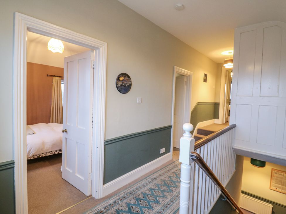 A hallway with doors and a bed visible at The Farmhouse in Whitchurch, Buckinghamshire