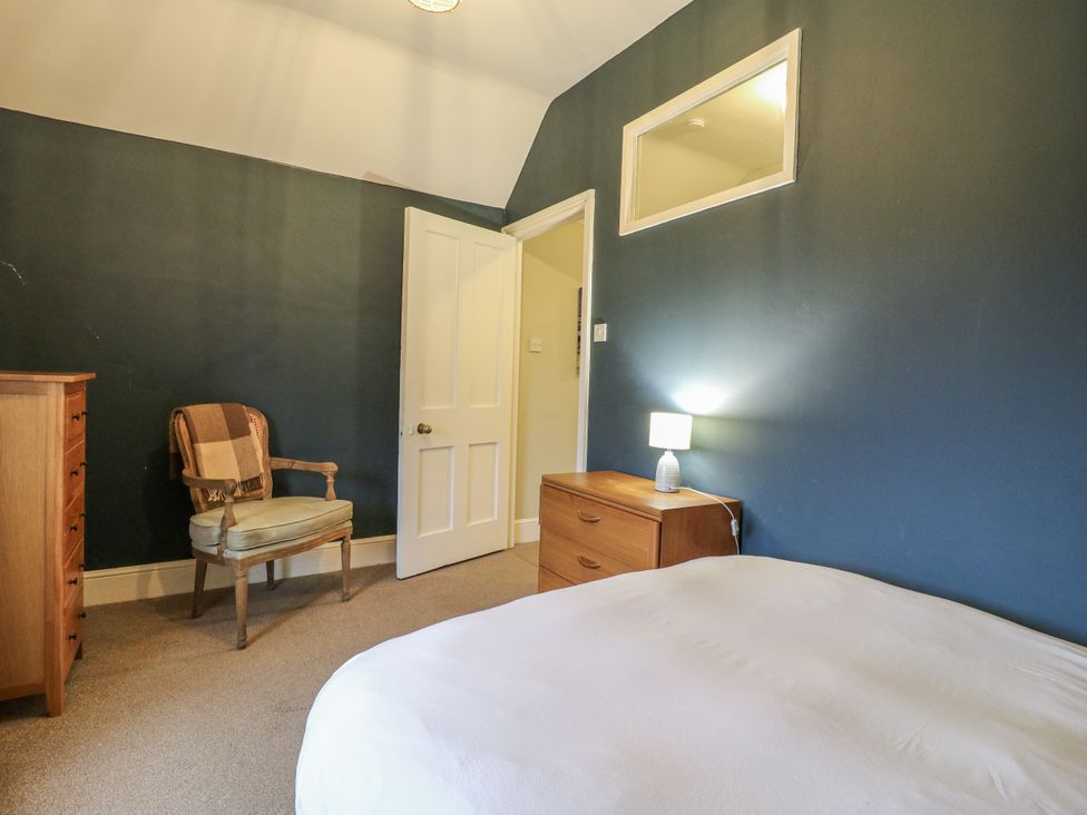 A bedroom with a bed and a chair at The Farmhouse in Whitchurch, Buckinghamshire