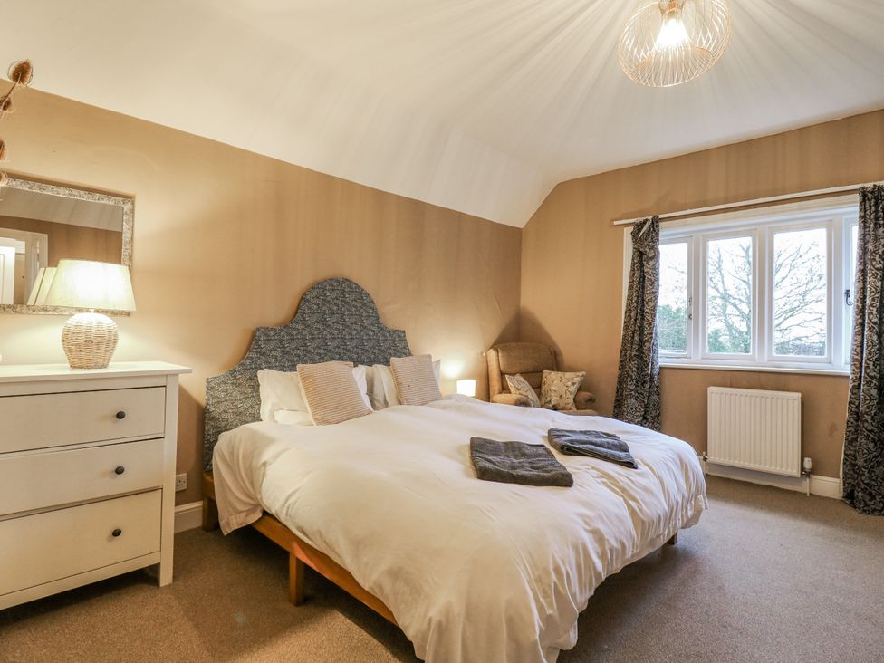 A bedroom with a double bed and nightstand at The Farmhouse in Whitchurch, Buckinghamshire