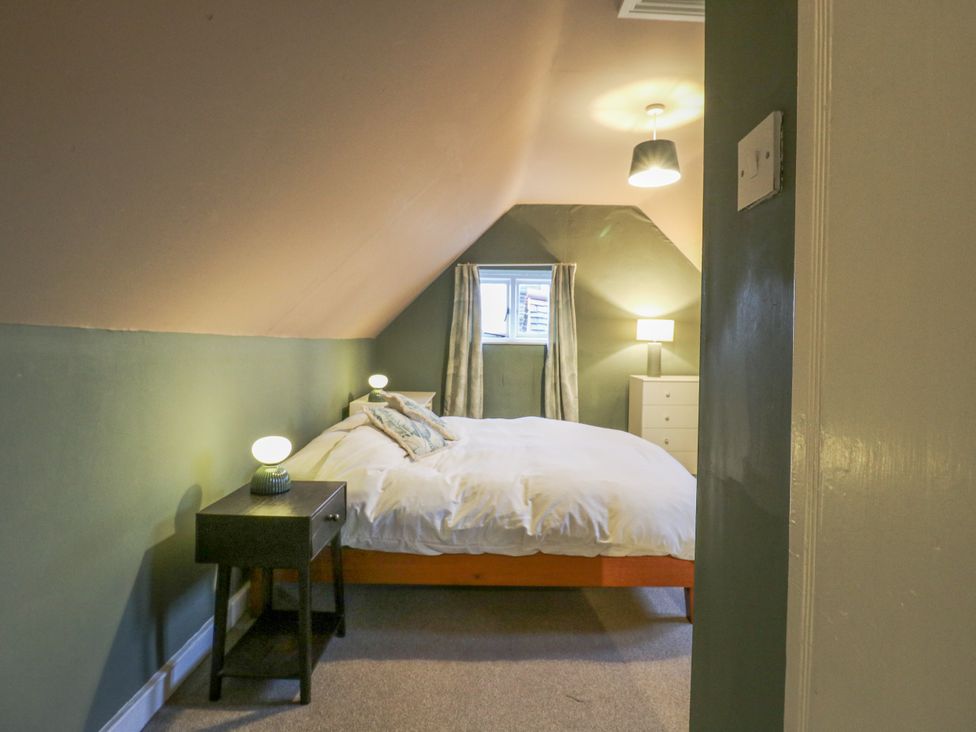 A bedroom with a bed and nightstand at The Farmhouse in Whitchurch, Buckinghamshire