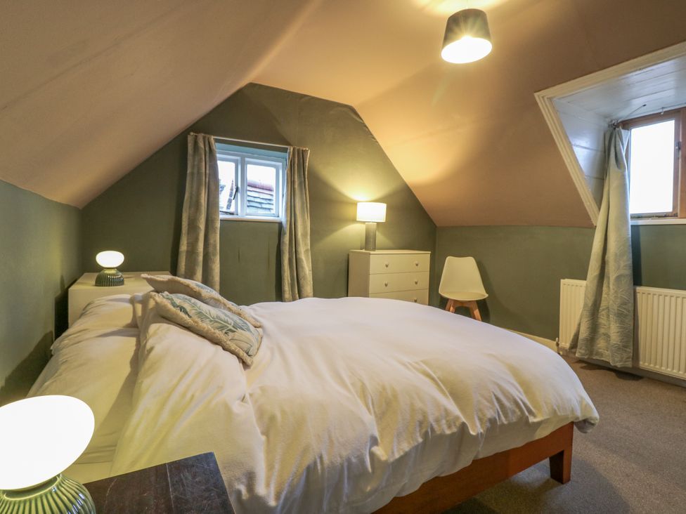 A bedroom with a bed and window at The Farmhouse in Whitchurch, Buckinghamshire