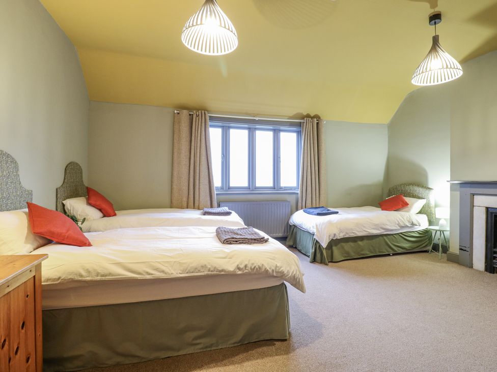 A bedroom with three beds and a window at The Farmhouse in Whitchurch, Buckinghamshire