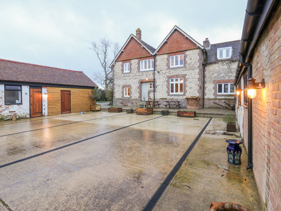 An outdoor area with a house and seating at The Farmhouse in Whitchurch, Buckinghamshire
