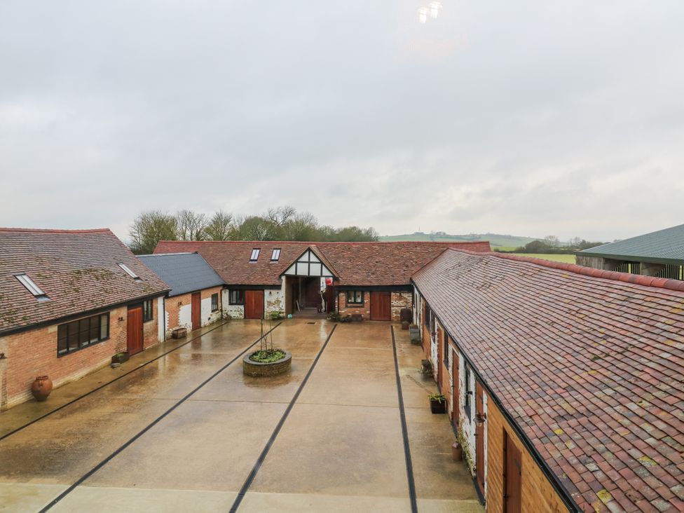 A courtyard with multiple buildings at The Farmhouse in Whitchurch, Buckinghamshire