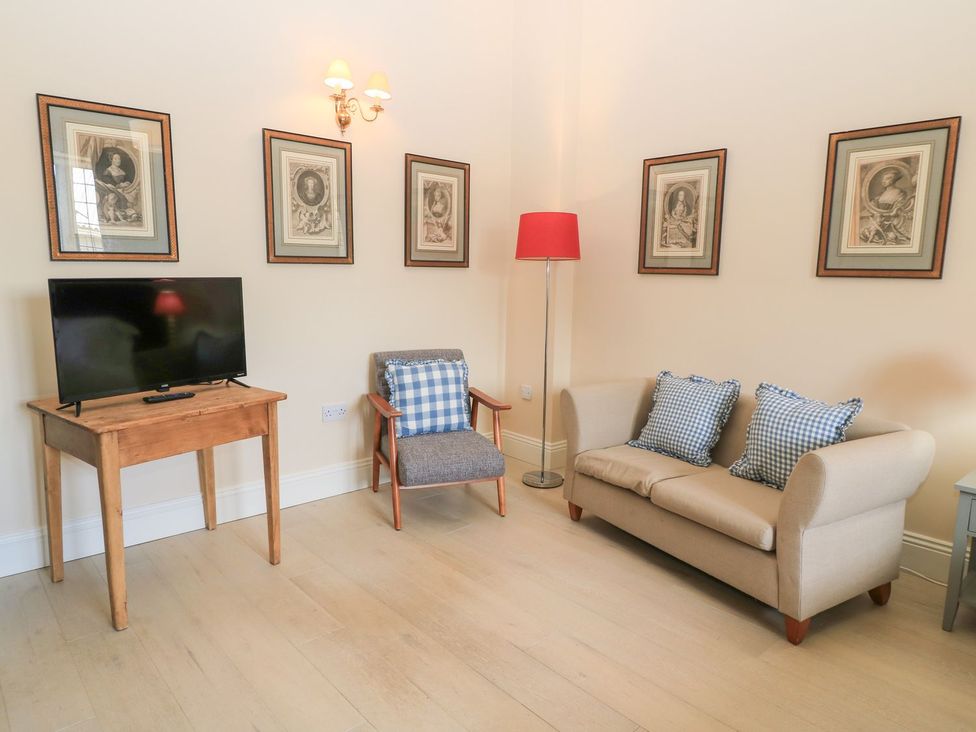 A living room with a television and seating area at Woodcock Studio Andoversford near Cheltenham