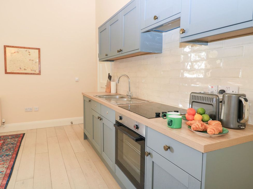 A kitchen with cabinets and appliances at Woodcock Studio Andoversford near Cheltenham