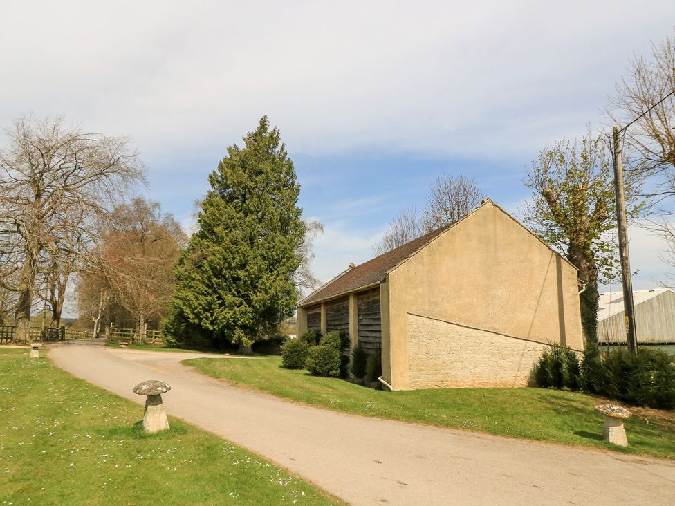 A house with trees and a driveway at Woodcock Studio Andoversford near Cheltenham